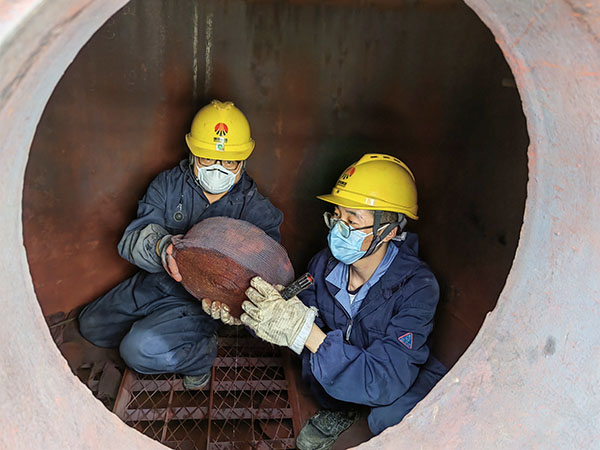 5月11日，動力車間三期工藝除氧器內(nèi)部，黨員突擊隊(duì)隊(duì)員劉瑞斌和李震正在清理舊填料.jpg