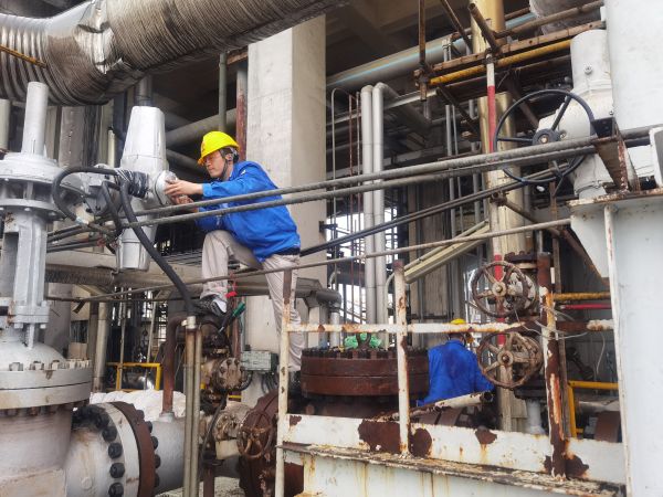 氣化爐上，柳曦、徐騰飛冒雨調(diào)試氣化爐電動閥.jpg